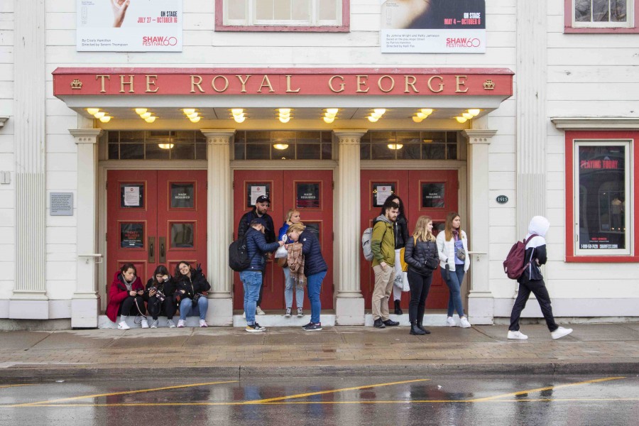 A group of people seeks shelter from the storm under the marquee at the Royal George Theatre on Sunday, May 1. (Richard Harley)
