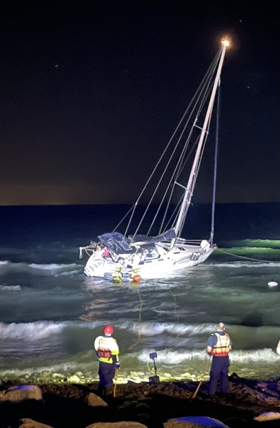 NOTL and St. Catharines fire crews help the stranded couple off their boat early Thursday. (Nick Ruller)