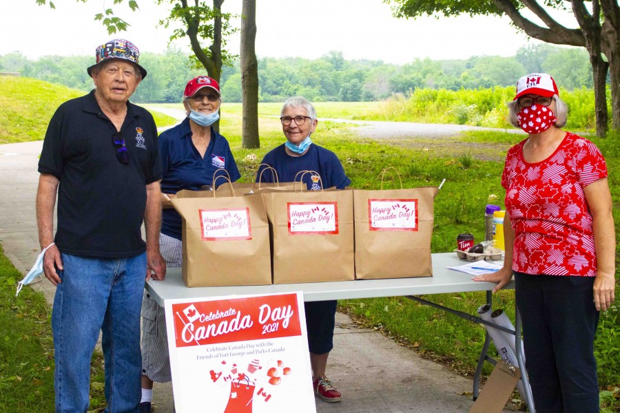 John Sayers, Judith Sayers, Nancy Wilkes and Maureen Hayslip hand out Canada Day packages out front of Fort George on June 30. (Evan Saunders)